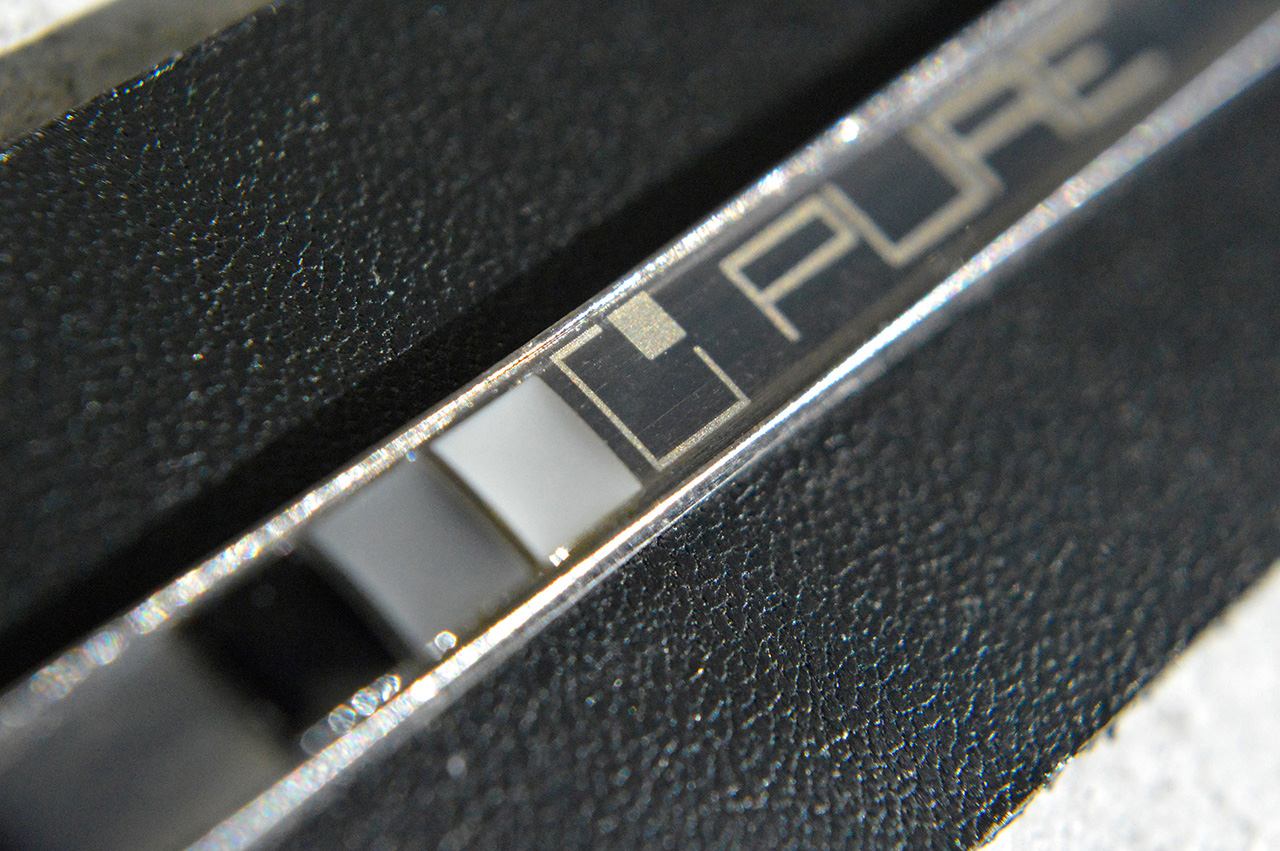 Metal plate on leather label close up